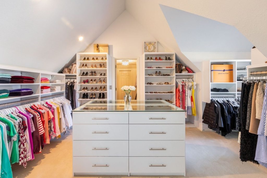 Image of a custom closet with a center island in a Newport Beach home.
