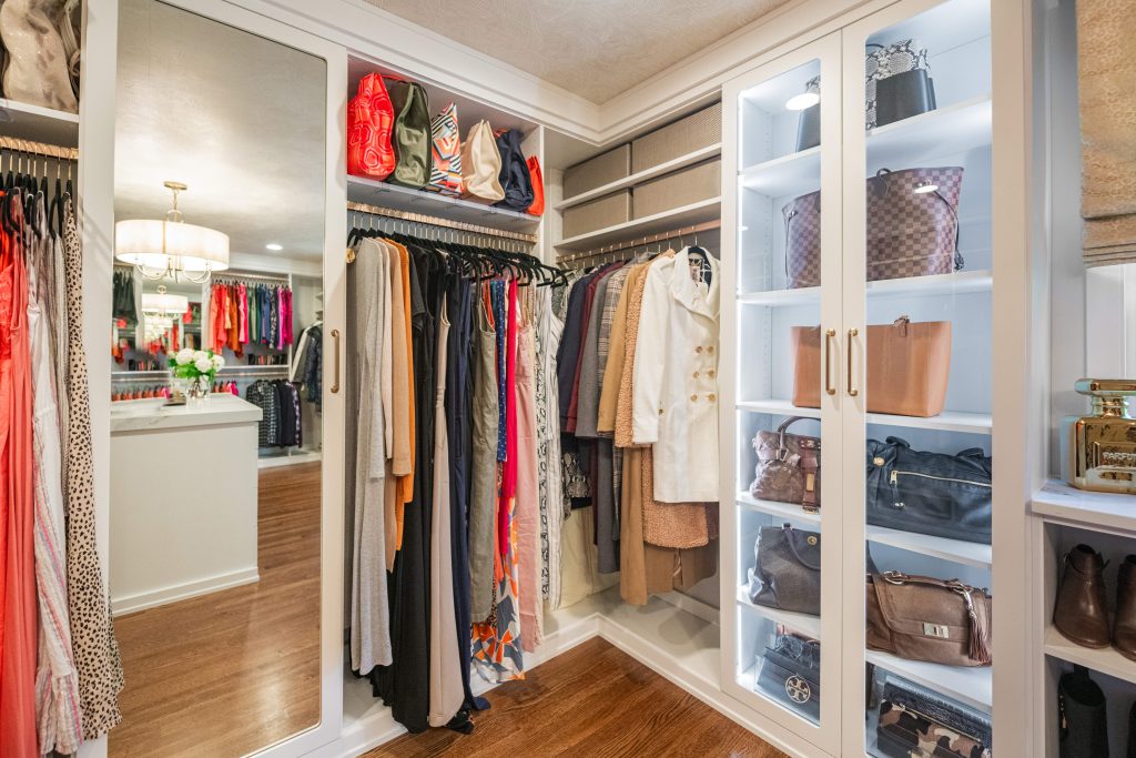Enclosed cabinetry in custom closet design.