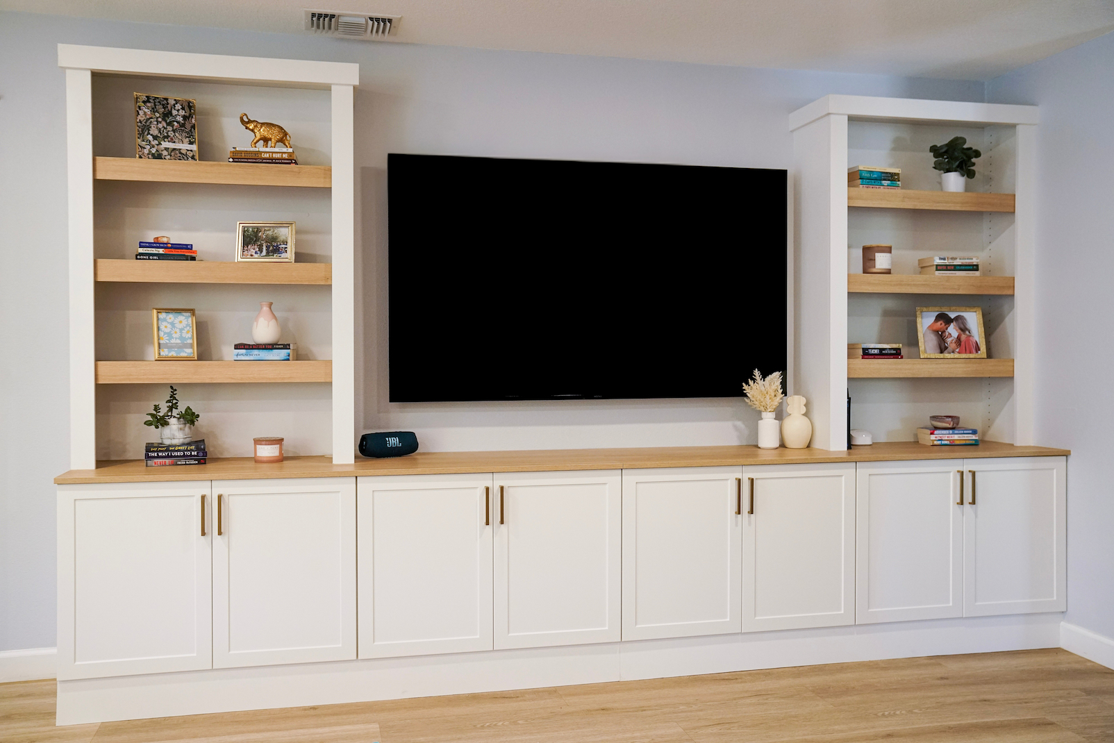 Built-in cabinetry with open shelving and concealed storage designed to keep living spaces clean and organized