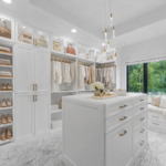 Image of large custom walk-in closet with closet island.